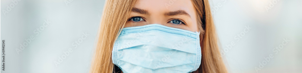A young woman in the background of an educational institution wearing an anti-coronavirus mask A young woman in the background of an educational institution wearing an anti-coronavirus mask