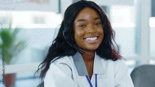 Portrait of beautiful nice young intern african american woman positively smile to camera waiting for patients in her medical office hospital private clinic environment. Medical specialist. Doctor.
