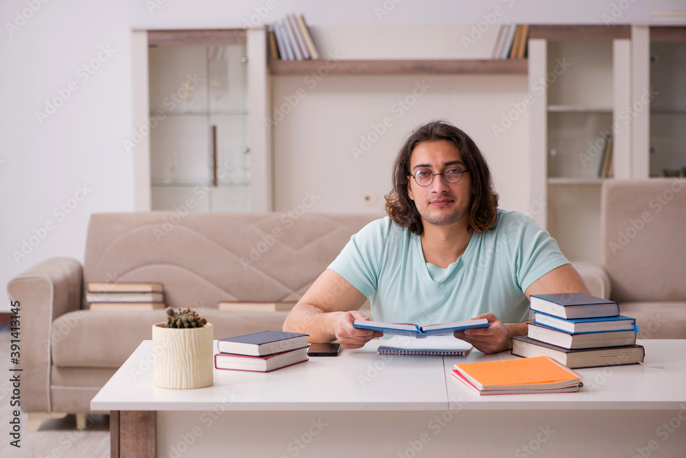 Young male student preparing for exams at home Young male student preparing for exams at home