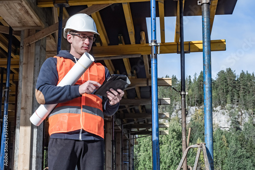 Builder with a tablet and d...