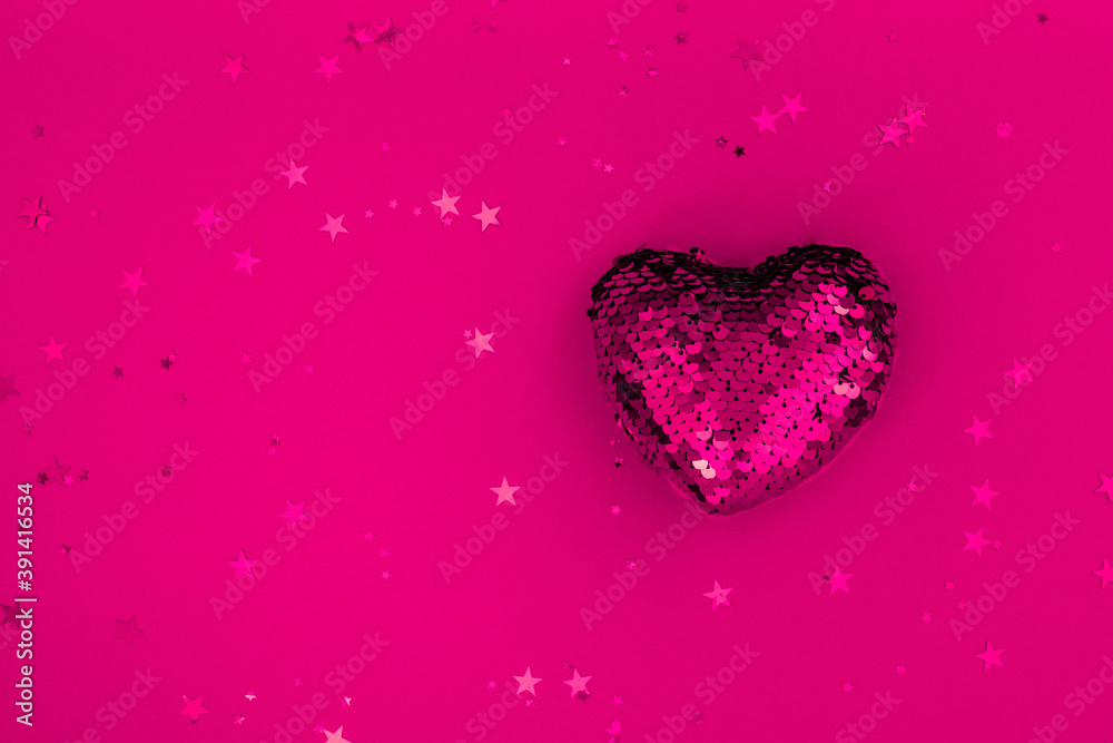 Christmas or Valentines composition made from glowing red heart decoration and glitter on purple surface. Merry christmas and happy 2021 New Year, Happy Valentine concept. Flat lay, top view, banner