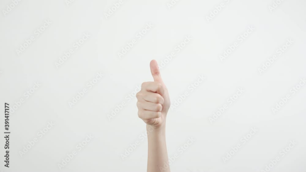 Close up of woman hand showing the thumb raised up, like sign on the white background. Close up of woman hand showing the thumb raised up, like sign on the white background.