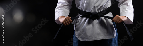 TaeKwonDo Karate teenager athlete kick punch black background isolated photo