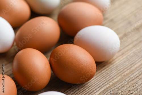 Fresh Chicken eggs and duck eggs on wooden background / white and brown egg.