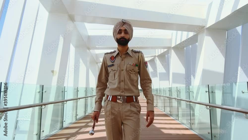 Punjabi police officer doing his rounds -mid shot