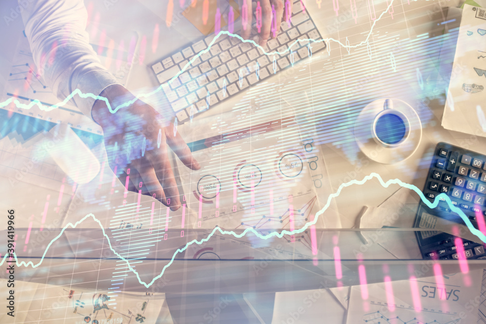 Multi exposure of man's hands typing over computer keyboard and forex graph hologram drawing. Top view. Financial markets concept.