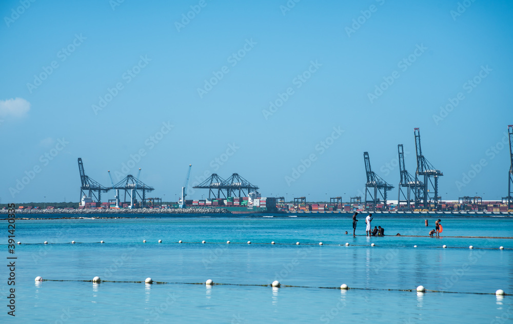 dramatic image of the shipping port on the caribbean ocean in Boca Chica, dominican republic, with aqua blue sea.