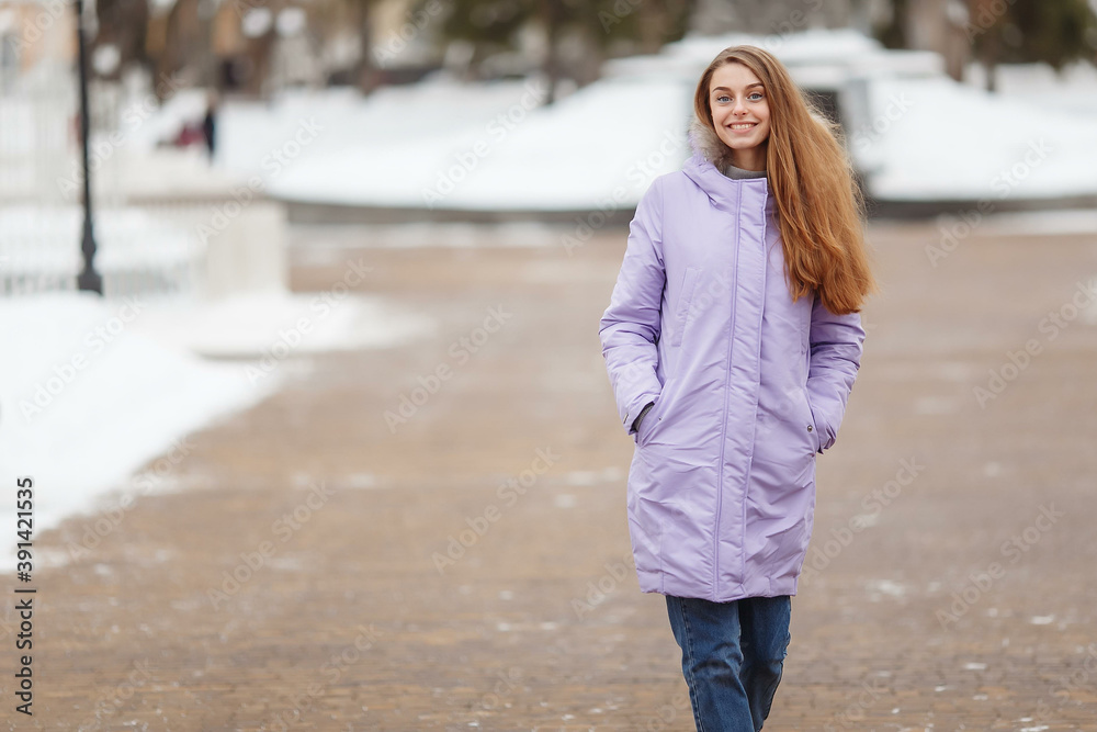 young woman are walking in the winter park. Winter park in the snow. Clothing advertising photo concept young woman are walking in the winter park. Winter park in the snow. Clothing advertising photo concept