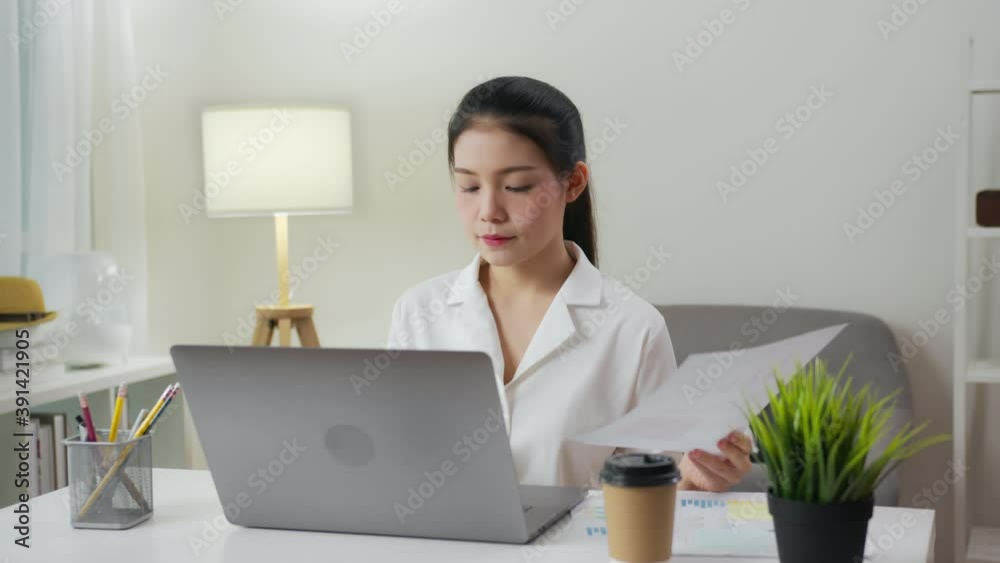 Business woman making a bored face and working on computers and documents with receive many files. Business woman making a bored face and working on computers and documents with receive many files.