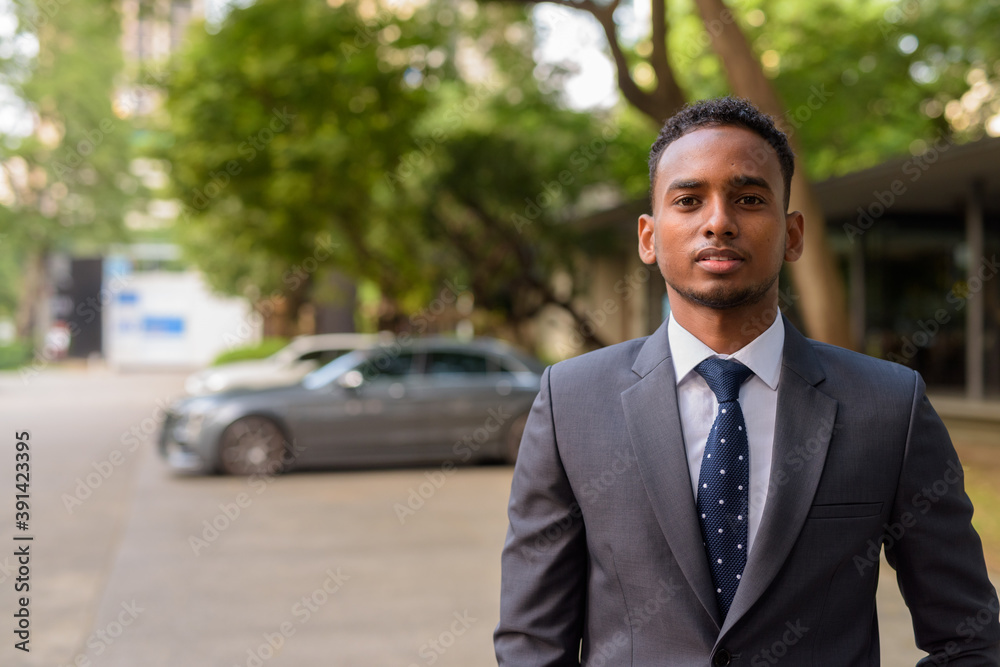 Portrait of young handsome African businessman outdoors Portrait of young handsome African businessman outdoors