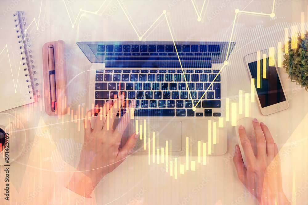 Double exposure of woman hands working on computer and forex chart hologram drawing. Top View. Financial analysis concept. Double exposure of woman hands working on computer and forex chart hologram drawing. Top View. Financial analysis concept.
