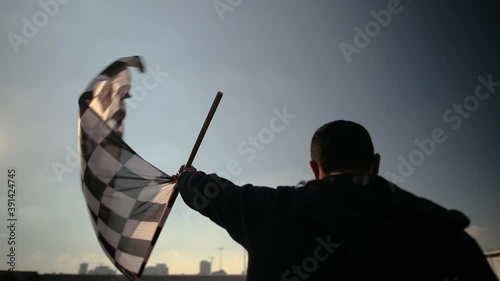 man waving karting racing flag photo