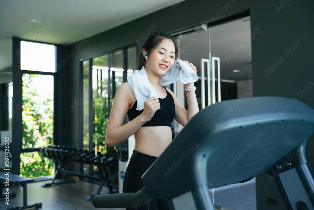 Healthy woman running on treadmill machine in gym. Healthy woman running on treadmill machine in gym.