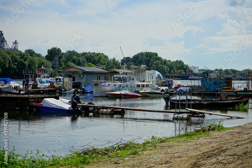 GIURGIU, ROMANIA - Jun 17, 2020: boats in small harbour on a Danube canal photo