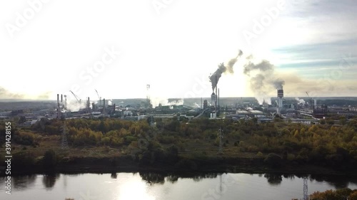 Aerial view of industrial area with chemical plant. Smoking chimney from factory. Chemistry factory in Lithunia, Achema. Production, industrial. Drone motion aerial shot. photo