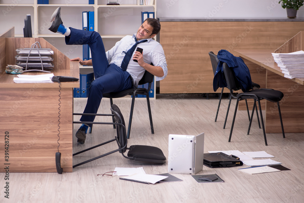 Young male businessman employee unhappy with his work Young male businessman employee unhappy with his work