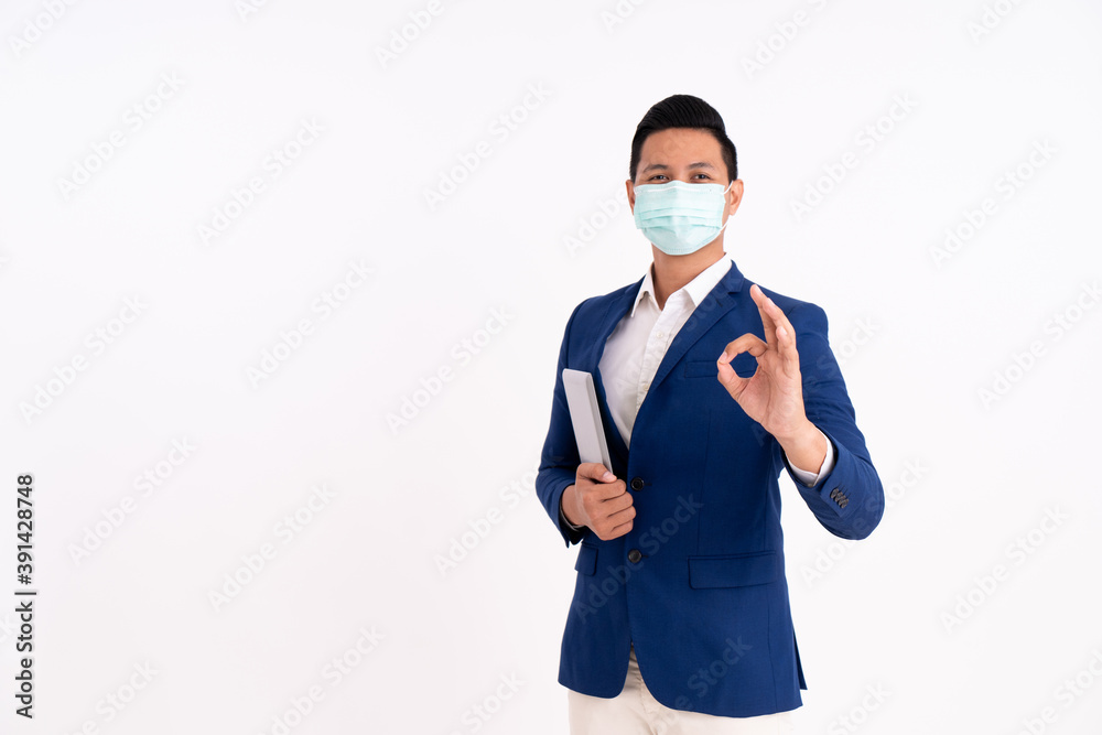 Portrait of a happy businessman. Showing OK sign with masks for health Portrait of a happy businessman. Showing OK sign with masks for health