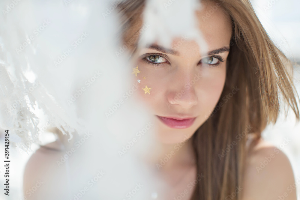 Attractive beauty woman face with star make up freckles. Portrait of a girl. High quality photo.