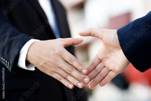 Closeup of a businessman hand shake investor between two colleagues ok, success.