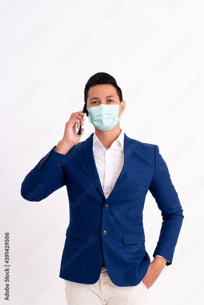 Portrait of a busy businessman. Viewing his project on a phone with masks for health Portrait of a busy businessman. Viewing his project on a phone with masks for health