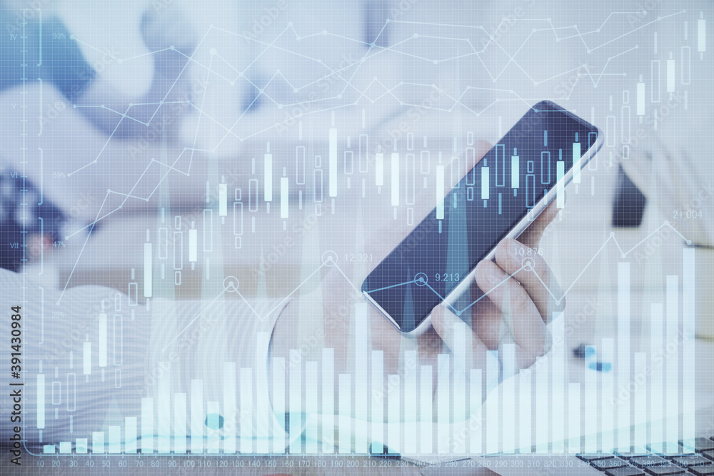 Double exposure of man's hands holding and using a digital device and forex graph drawing. Financial market concept. Double exposure of man's hands holding and using a digital device and forex graph drawing. Financial market concept.