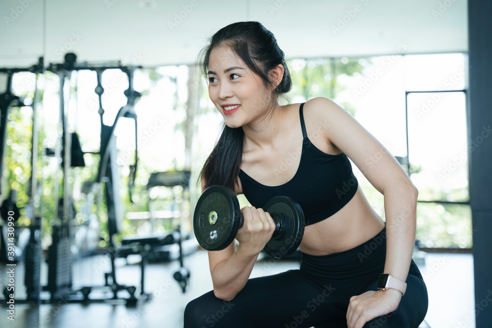 Healthy asian woman exercise with dumbbell in gym. Healthy asian woman exercise with dumbbell in gym.