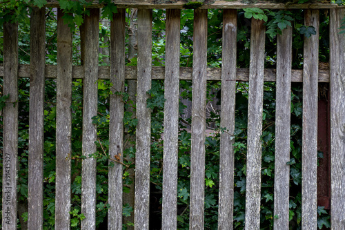Elements of an old wooden fence on a ranch on a summer day.