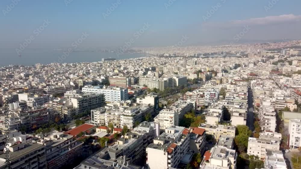 Aerial view of urban environment, road with cars, buildings and houses in the city of Thessaloniki, Greece, movement from above and to the side by drone Aerial view of urban environment, road with cars, buildings and houses in the city of Thessaloniki, Greece, movement from above and to the side by drone