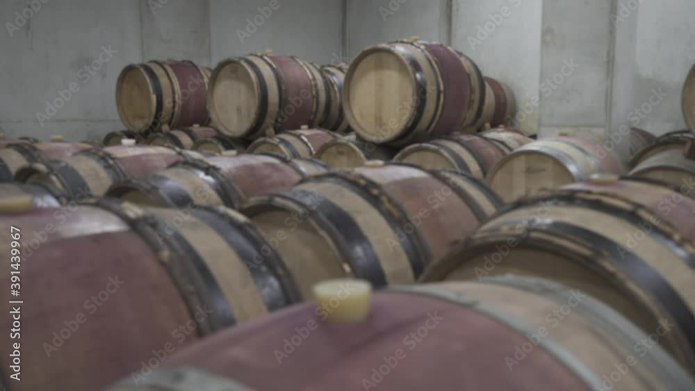 Soft focus, slide left on red wine wooden barrels in a concrete cellar, cali Soft focus, slide left on red wine wooden barrels in a concrete cellar, cali