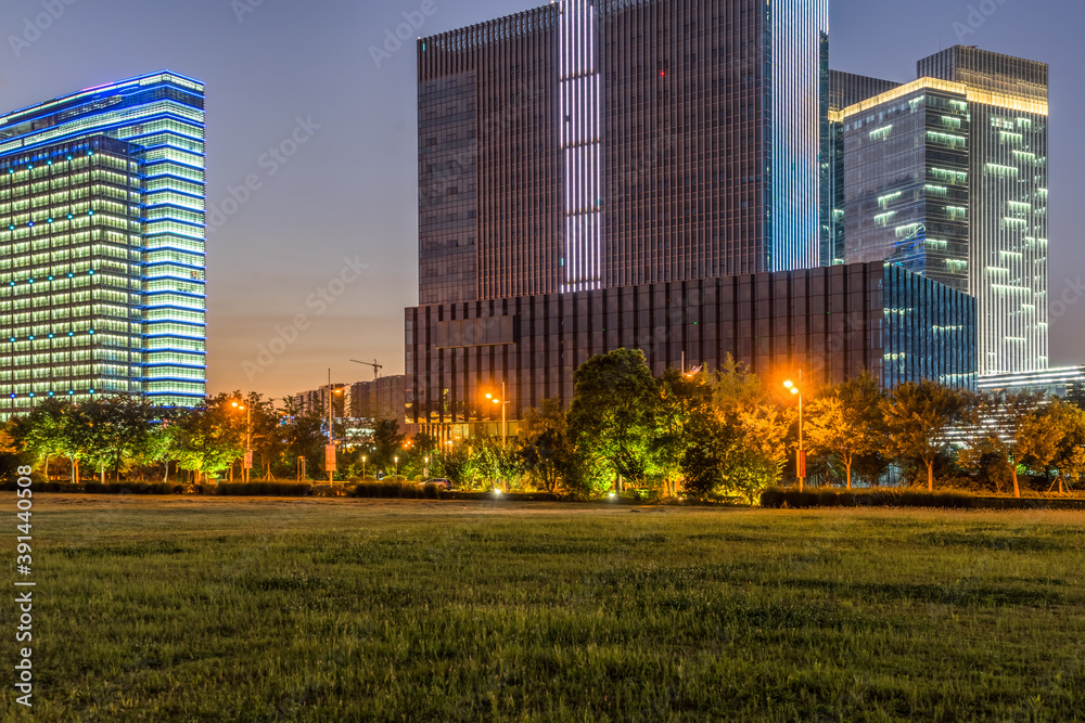 Fototapeta premium modern office buildings near meadow in midtown