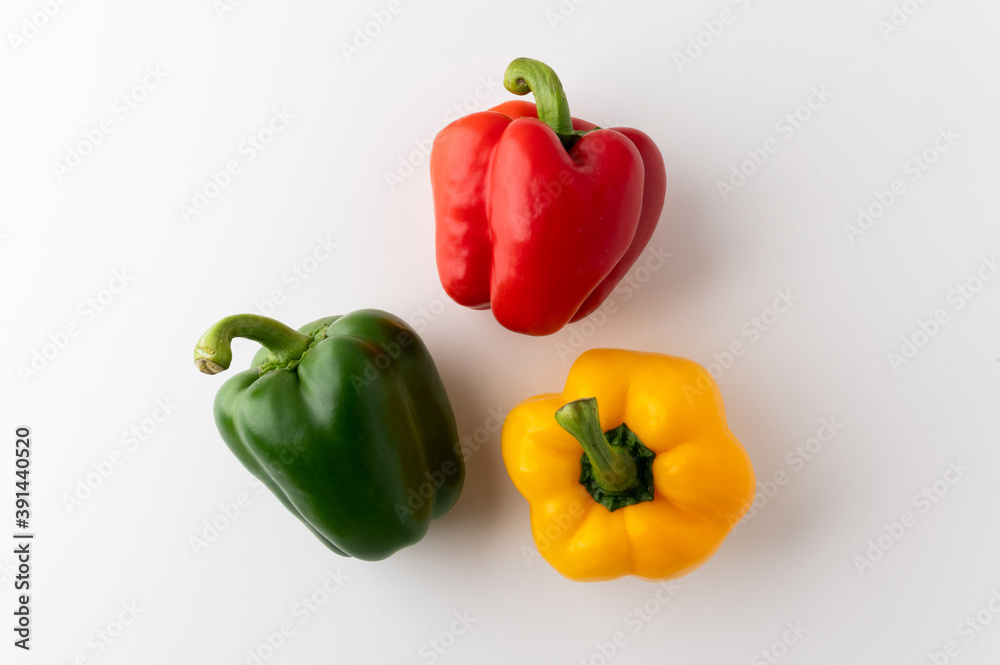 Colorful raw red yellow green of bell pepper above view on isolated white background. Healthy vegetables and food. Colorful raw red yellow green of bell pepper above view on isolated white background. Healthy vegetables and food.