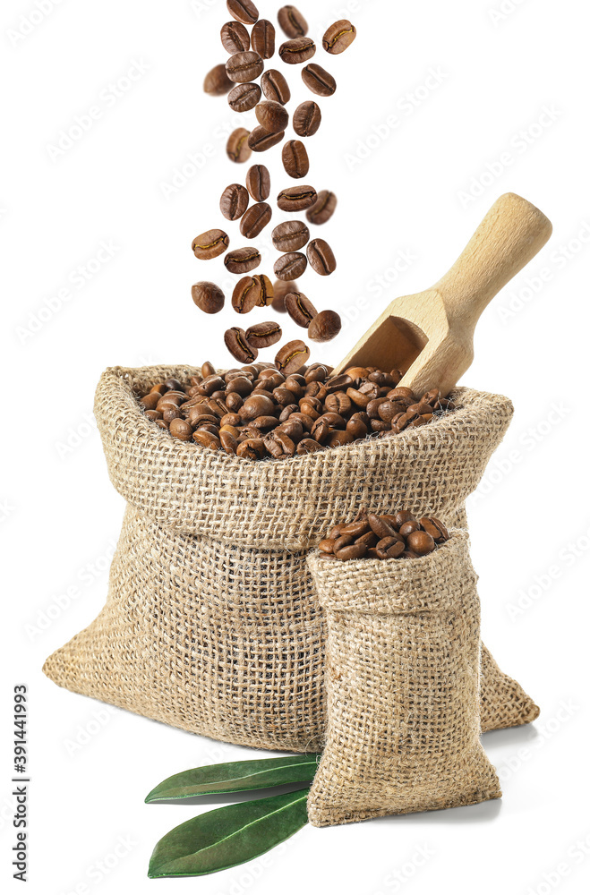 Bags with falling coffee beans on white background Bags with falling coffee beans on white background