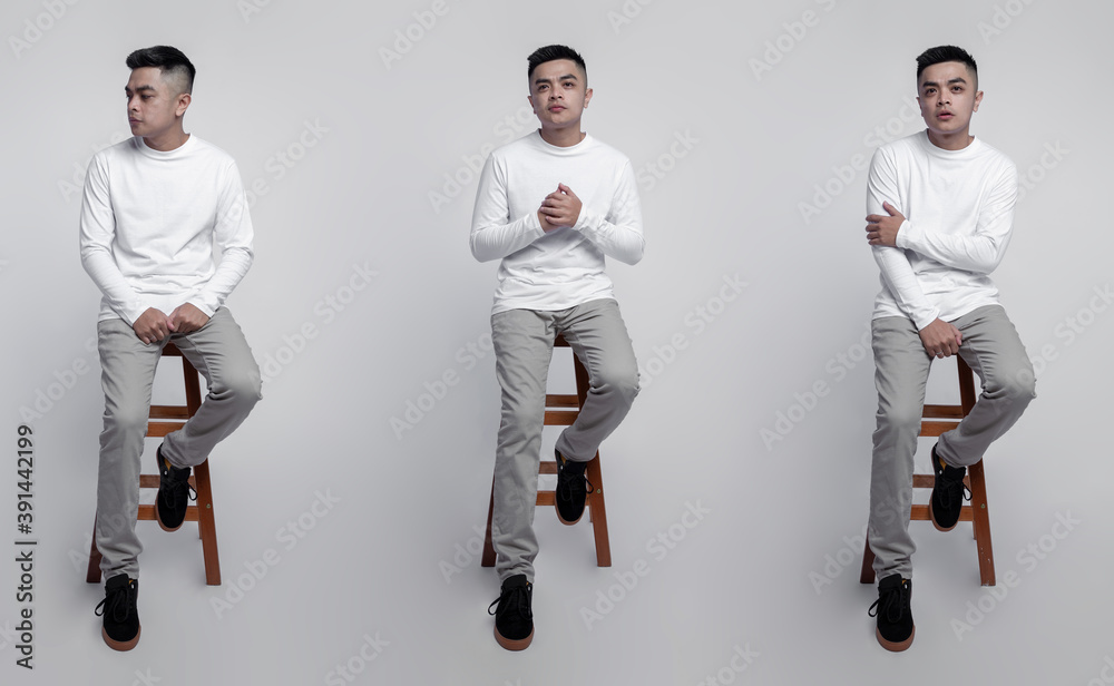 Handsome man wearing white long sleeve t-shirt was sitting on a chair with a plain background