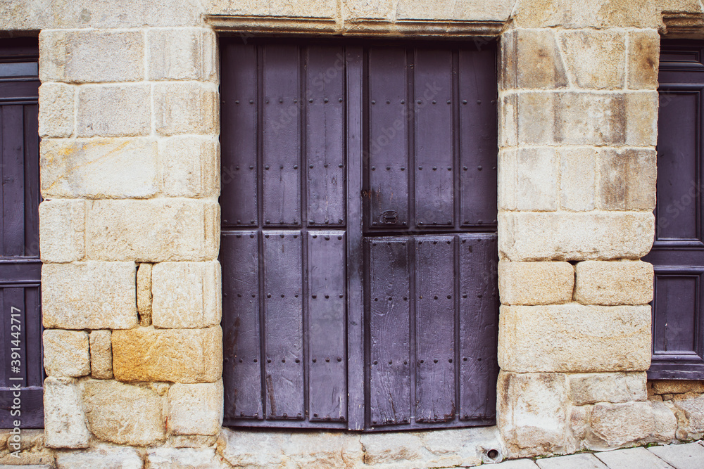 violet painted wooden door on stone frame violet painted wooden door on stone frame