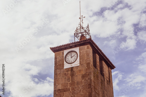 Clock tower of the church of Santiago with clouds i