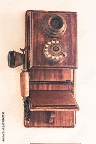 old wooden phone on white wall