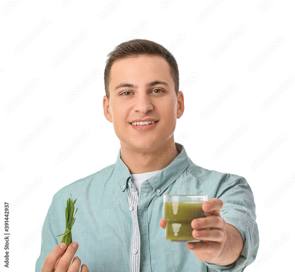 Young man with wheatgrass and juice on white background Young man with wheatgrass and juice on white background