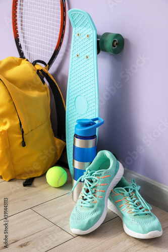 Fototapeta Naklejka Na Ścianę i Meble -  Set of sport equipment on floor near color wall
