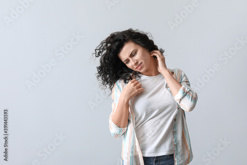 Allergic young woman scratc...