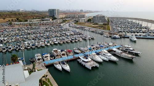 Yachts swimming and lighthouse in Herzliya marina, Israel, aerial drone. High quality 4k footage