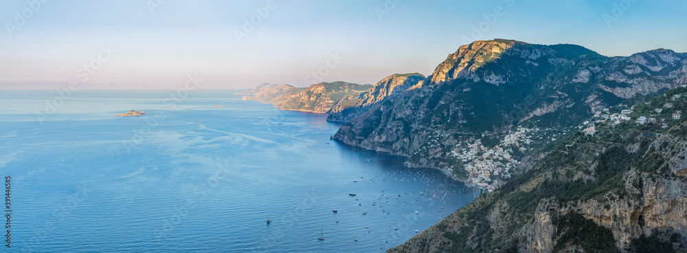 Panoramic view of Amalfi Coast, with Positano seaside village and beach, leisure boats moored in a bay and scenic cliffs from famous hiking path of the Gods in Campany, Italy