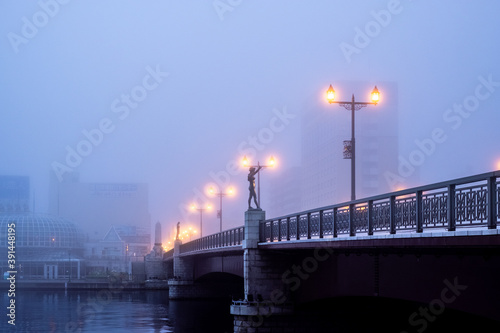 Foggy view around Nusamaibashi Bridge with illuminated street lamps in Kushiro City
