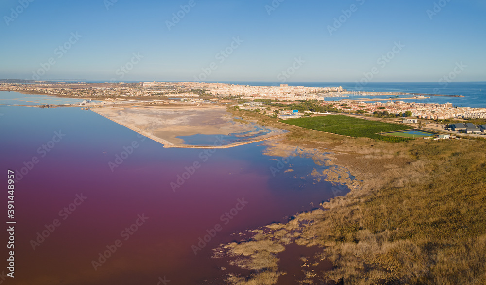 The Spanish city of Torrevieja with the salt lagoon in the foreground. On the right you can see the Mediterranean Sea and the port with the salt terminal.
