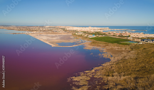 The Spanish city of Torrevieja with the salt lagoon in the foreground. On the right you can see the Mediterranean Sea and the port with the salt terminal.