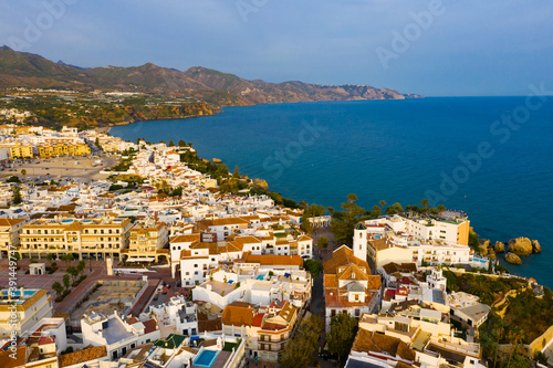 Panoramic aerial view of Nerja city by Mediterranean coast on sunny day  Costa del Sol  Spain