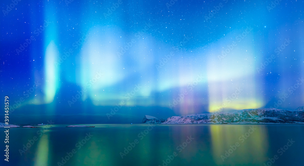 Naklejka premium Northern lights (Aurora borealis) in the sky over Tromso, Norway