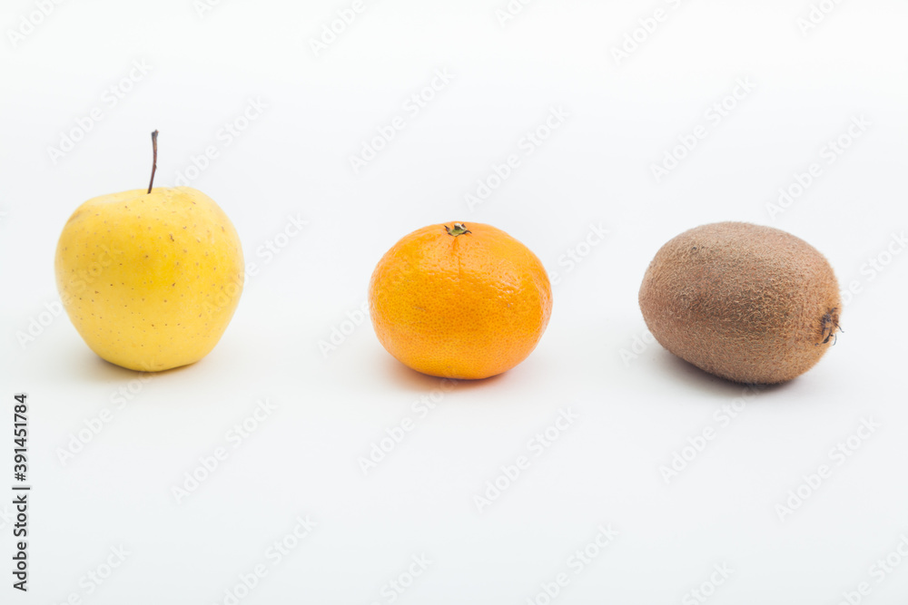 Orange tangerine and whole kiwi with yellow apple Orange tangerine and whole kiwi with yellow apple