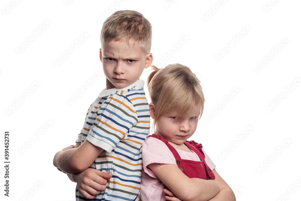 brother and sister are fighting on a white background. offended at each other. gloomy relatives brother and sister are fighting on a white background. offended at each other. gloomy relatives