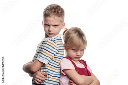 brother and sister are fighting on a white background. offended at each other. gloomy relatives
