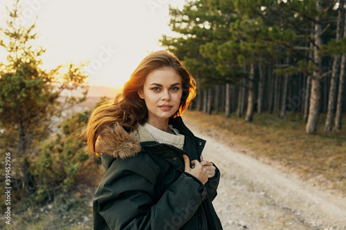 Woman tourists warm jacket cropped view of travel trees In the background